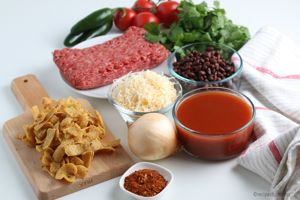 Frito Pie Ingredients including fritos, cheese, black beans, cheese and taco seasoning