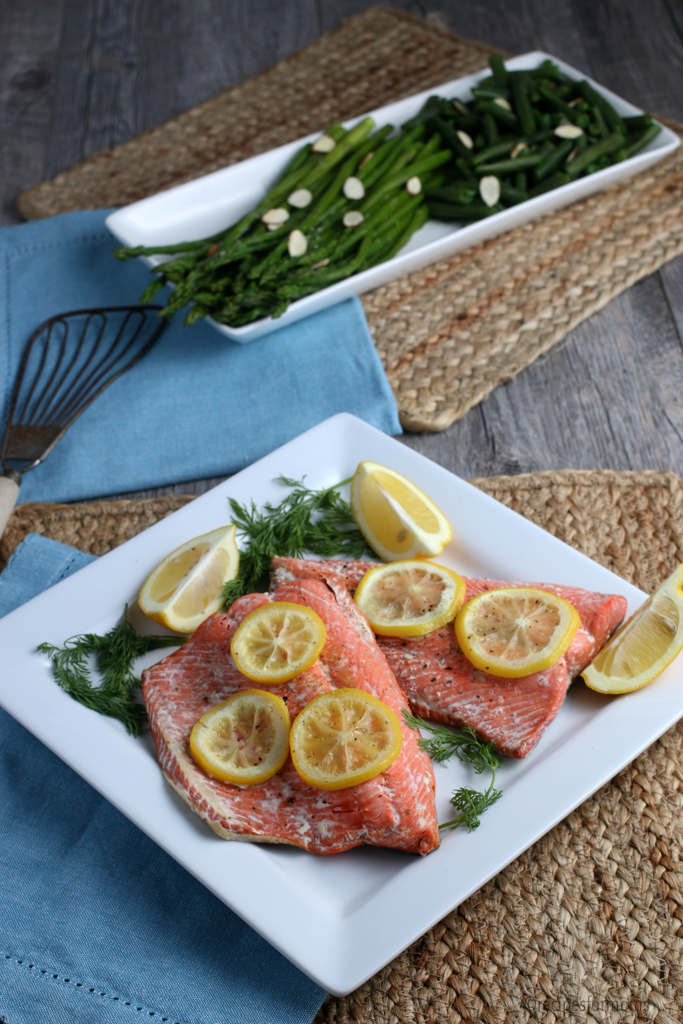 Instant Pot Salmon garnished with lemon slices and served with asparagus